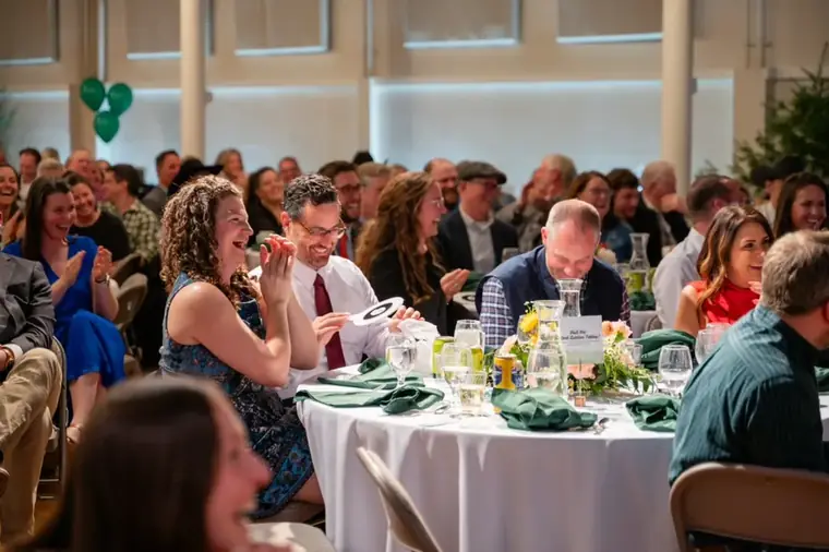 Guests raising paddles during a fundraising gala