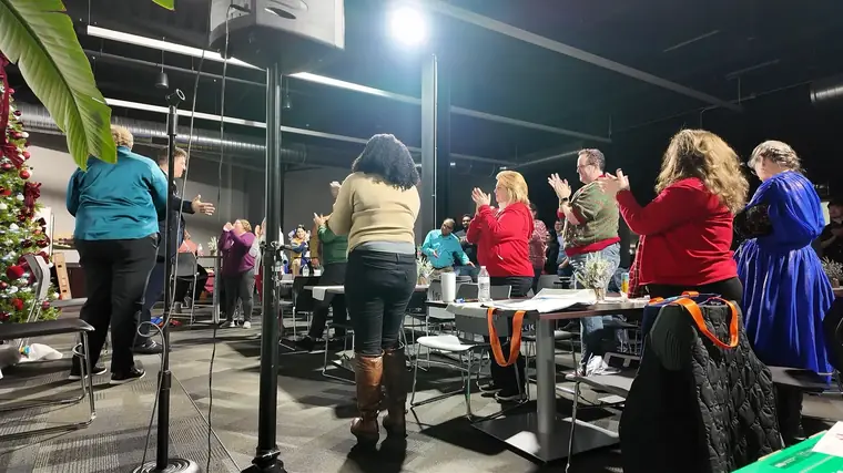 A company holiday party crowd on its feet