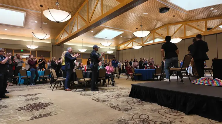 Daniel C. Schaffer on stage with volunteers from the audience